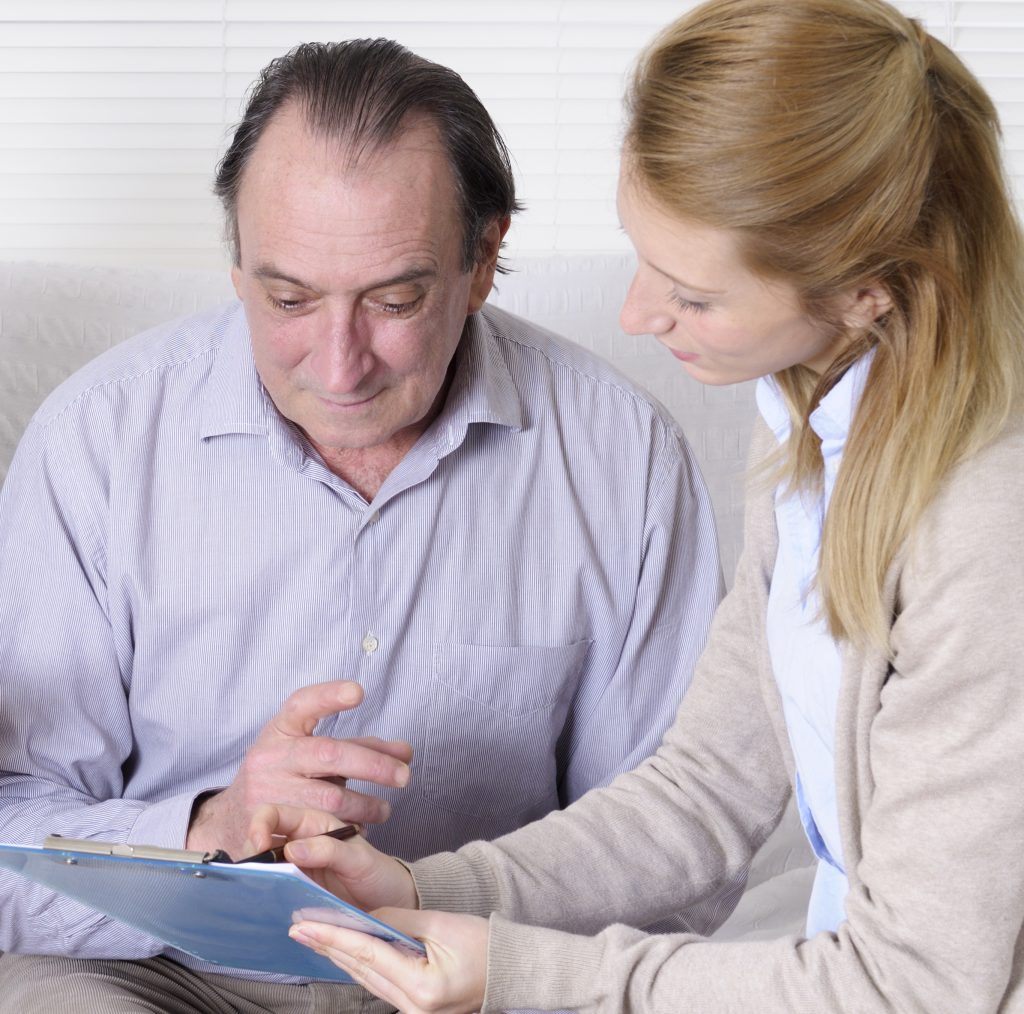 Senior Man giving performance review to caregiver